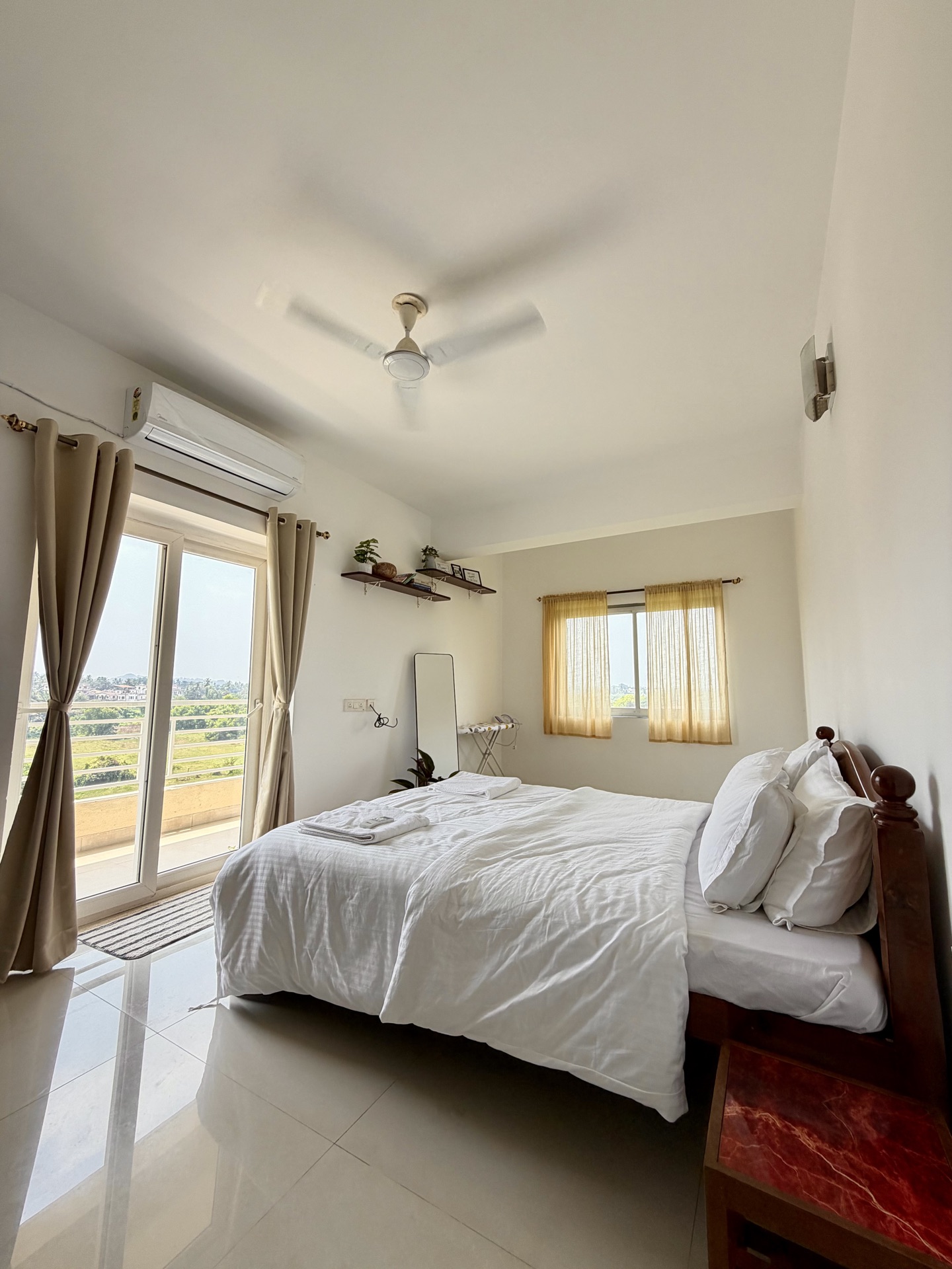 Bedroom with balcony view of Goa countryside