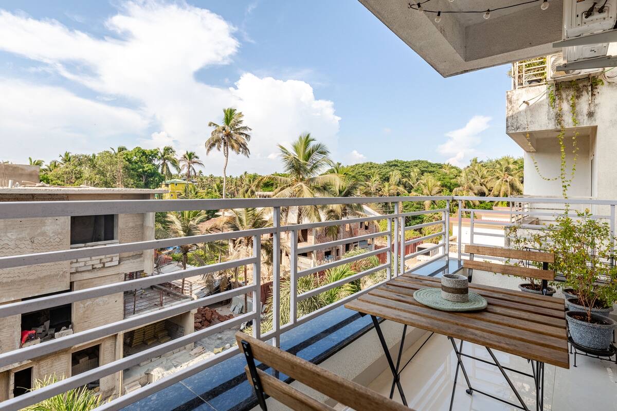 Balcony with bistro set and coconut palm views