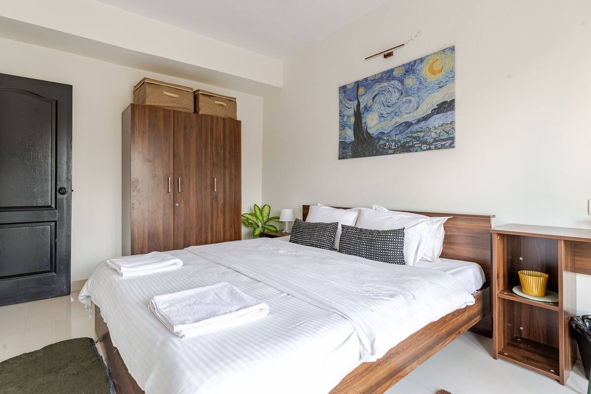 Bedroom with Starry Night painting and wardrobe