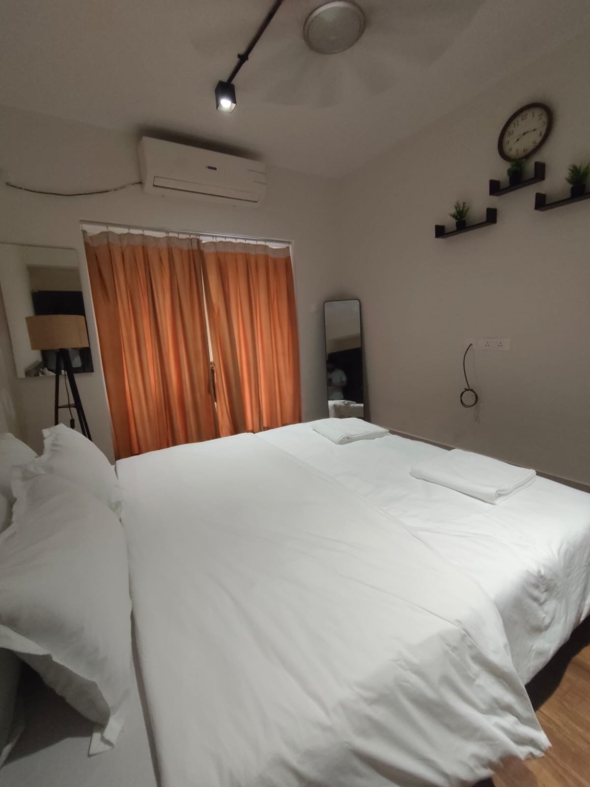 Bedroom at night with warm orange curtains and soft lighting